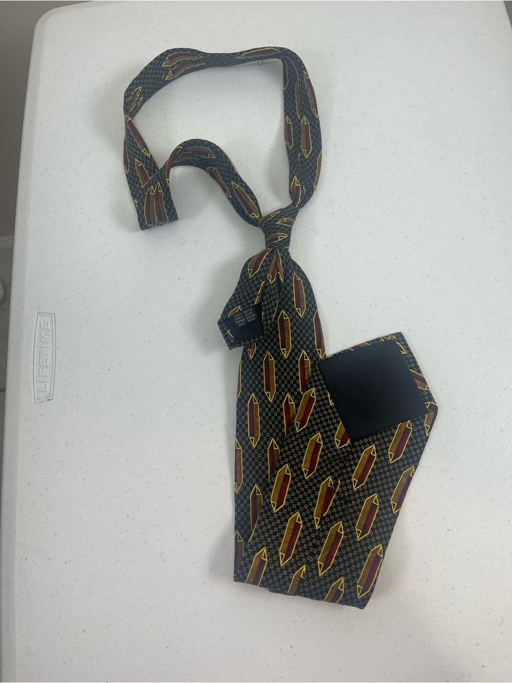 Men's Black Patterned Silk Tie with Red and Gold Accents